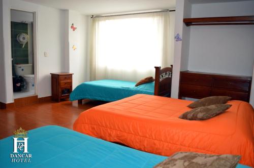 Postel nebo postele na pokoji v ubytování Hotel Dancar
