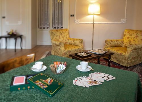 a living room with a table with a green table cloth at TH Borca di Cadore - Park Hotel Des Dolomites in Borca di Cadore