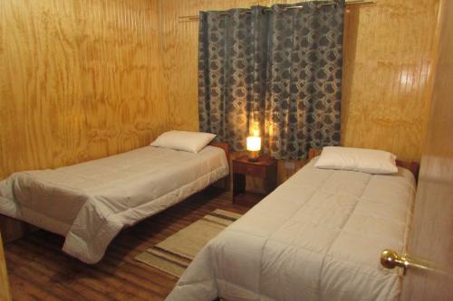 Säng eller sängar i ett rum på Cabañas El Maitén