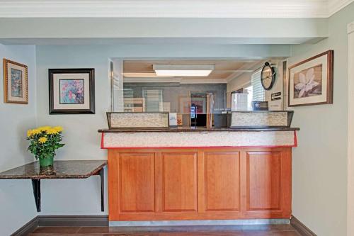 a kitchen with a counter and a mirror at Super 8 by Wyndham Sacramento/Florin Rd in Sacramento