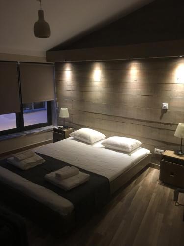 a bedroom with a large bed with two towels on it at Casa Lilia in Monchique