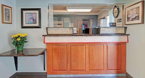 a kitchen with a counter with a counter top at Super 8 by Wyndham Sacramento/Florin Rd in Sacramento