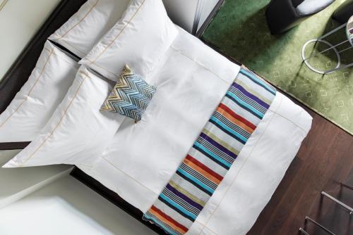 a white shirt with a tie on a table at The Joseph in Vilnius