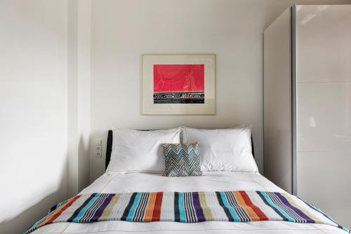 a bedroom with a bed with a colorful blanket on it at The Joseph in Vilnius