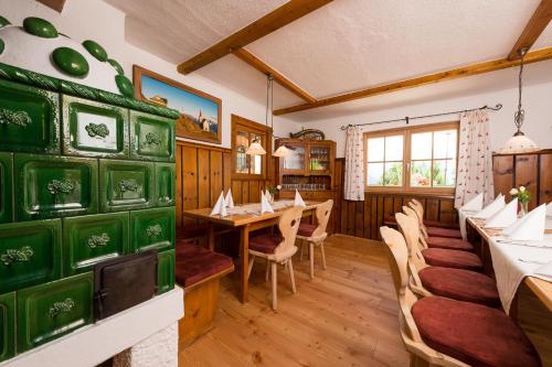 a dining room with tables and chairs in a restaurant at Gasthof Kronreith in Maria Alm am Steinernen Meer