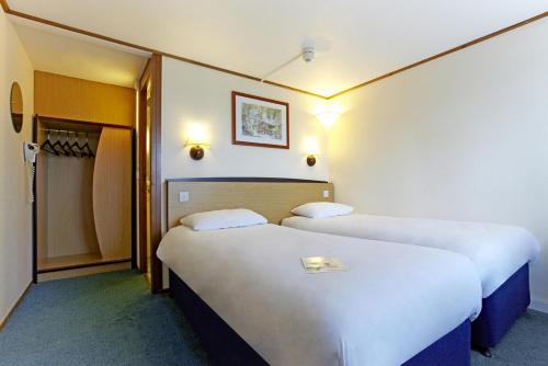 two beds in a hotel room with two at The Crossway Hotel, Part of AG Collection in Coventry