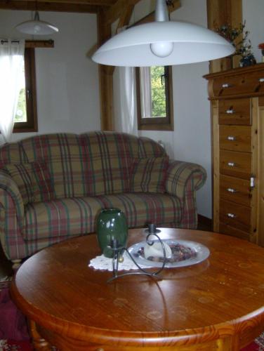a living room with a couch and a table at La Maison en Bois in Wibrin