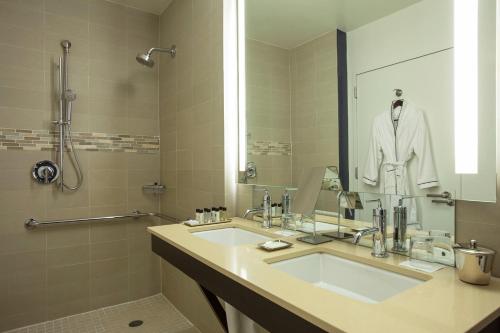 a bathroom with a sink and a large mirror at Hotel Hayden New York in New York