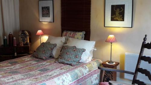バイユーにあるB&B Jardin et Hotel Particulierのベッドルーム1室(枕、ランプ2つ付)