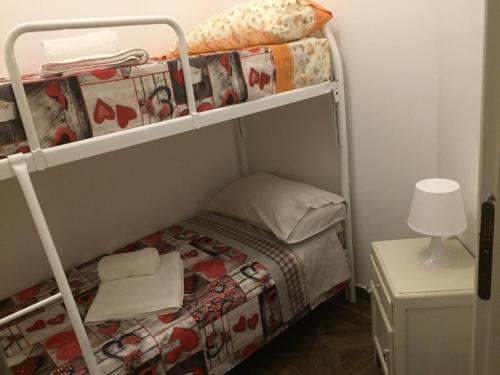 a small room with a bunk bed with a lamp at Chic & Beauty in Agrigento