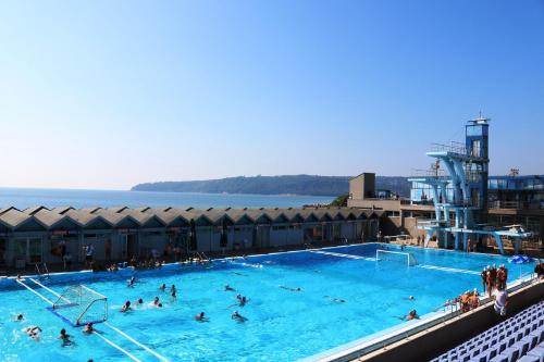 a large swimming pool with people in the water at Sea Port CELEBRITY Apartment - Lets4Holiday in Varna City