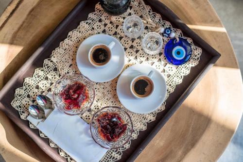 a tray with two cups of coffee on a table at Melidron Hotel & Suites in Agios Prokopios