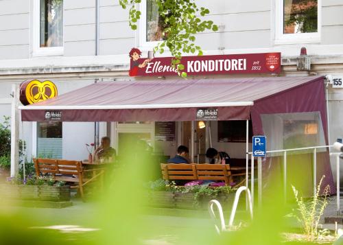 a restaurant with people sitting inside of it at Ellena`s FEWO am Uke in Hamburg