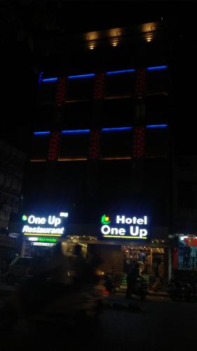 a hotel one up lit up at night at Hotel One Up in Ahmedabad
