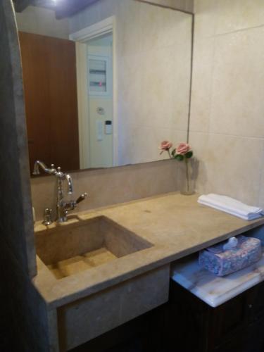 a bathroom with a sink and a mirror at CHRYSTALL'S COTTAGE in Lagonissi