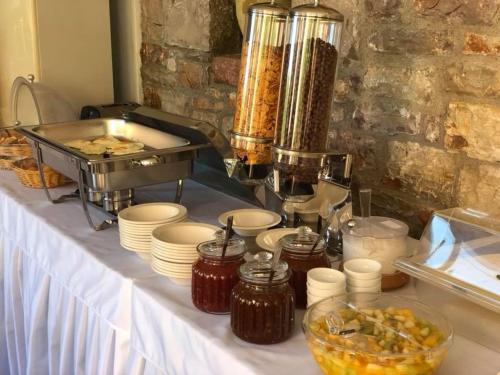 a table with a buffet of food on it at Petradi in Livadi