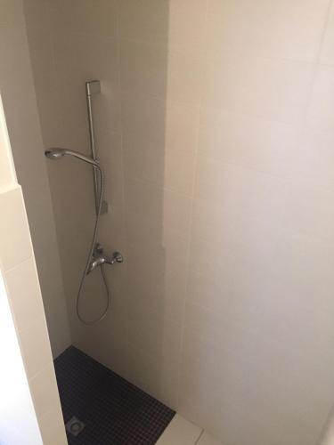a shower stall in a bathroom with a shower at Appart-Hôtel Résidence de Garonne in Tonneins