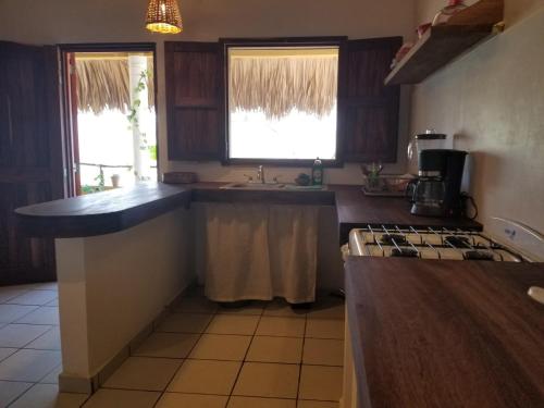 a kitchen with a sink and a counter top at Casa Aditi in Mazunte