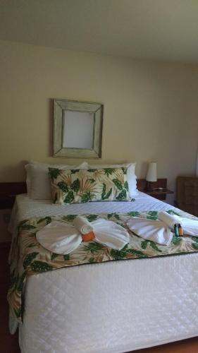 a bed with two pairs of underwear on it at Pousada Penedo in Penedo