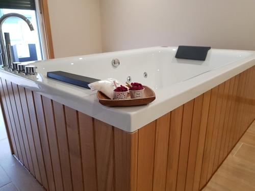 a bathroom counter with a bath tub with strawberries on it at Casa Chelo Alojamientos Turisticos in Mazaricos