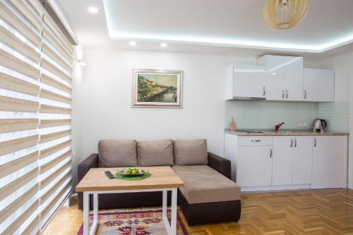 a living room with a couch and a table at Guest House Hendek in Sarajevo