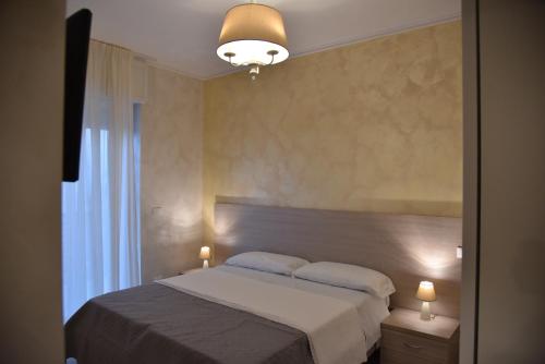 a bedroom with a bed and a large window at Vista beb mare in Manfredonia
