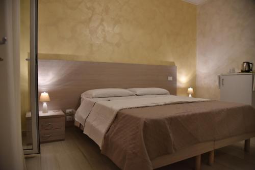 a bedroom with a large bed and a mirror at Vista beb mare in Manfredonia