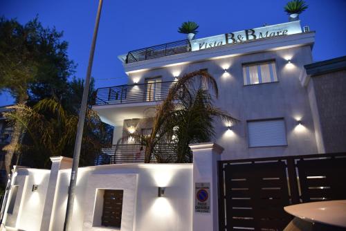 a white building with a sign on top of it at Vista beb mare in Manfredonia