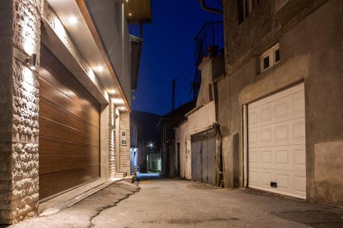 an alley with a white garage door at night at Guest House Hendek in Sarajevo