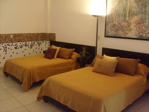 Ένα ή περισσότερα κρεβάτια σε δωμάτιο στο Hotel & Suites Mo Sak