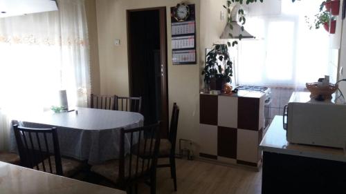 a kitchen and dining room with a table and chairs at Apartament cu 2 camere in Călimăneşti