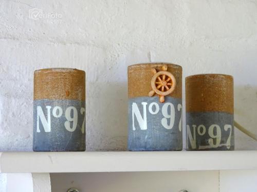 three metal cylinders sitting on top of a shelf at Dejeps in Punta Del Diablo