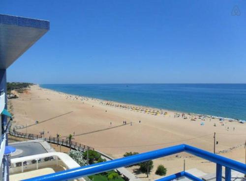 a view of a beach with people on it at Oceanides Beachfront Apartments in Quarteira