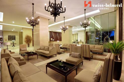 a lobby with couches and chairs and a chandelier at Swiss-Belhotel Sorong in Sorong