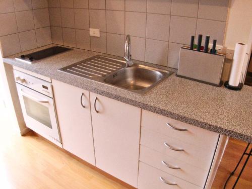 a kitchen with a sink and a stove at City Edge Nest in Wellington