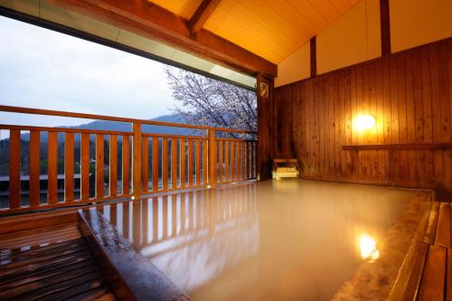 a porch with a bench on a balcony at Matsukaneya Annex in Zao Onsen