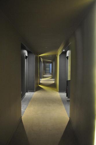 an empty hallway with yellow walls and a long corridor at Italiana Hotels Florence in Florence