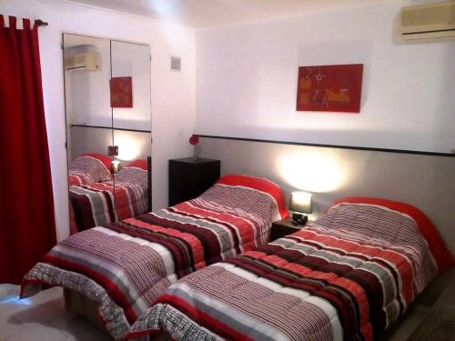a group of three beds in a room at Oroño 2 in Rosario