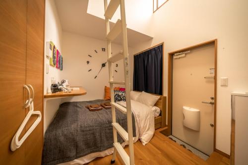 a bedroom with a bed and a bunk bed at Maison de Takinogawa in Tokyo
