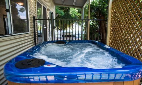 a hot tub on the back of a house at Farview Guest Accommodation in Pickering Brook