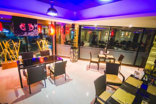 a restaurant with tables and chairs in a room at The Gallery At Koh Chang in Ko Chang