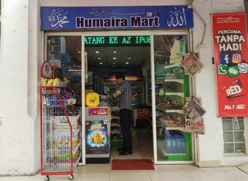 a man standing in the doorway of a store at Sun Inns Hotel Lagoon near Sunway Lagoon Theme Park in Petaling Jaya