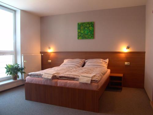 A bed or beds in a room at Penzion Ruland