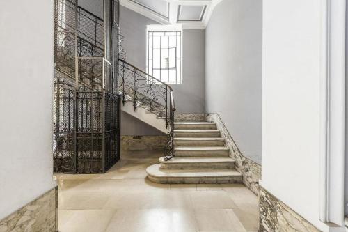 a staircase in a white building with a window at Residenza Vatican Suite in Rome