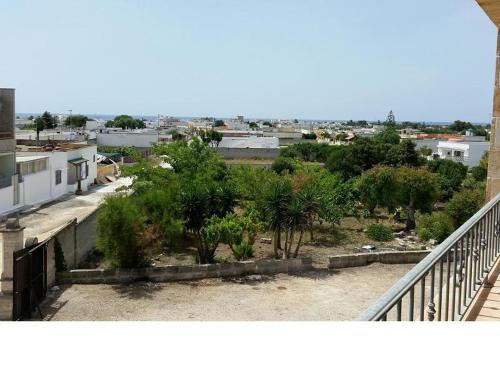 a view of a city from a balcony with trees at Casa Vacanza Via Lazio in Torre Lapillo