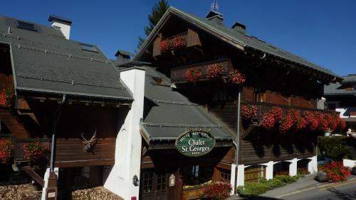 a building with a sign on the side of it at Hôtel Saint-Georges in Megève