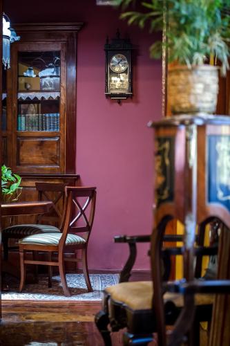 a room with chairs and a clock on a wall at Hotel Emblemático San Marcos in Icod de los Vinos