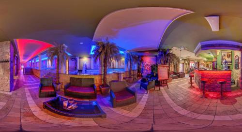 a lobby with a bar with colorful lights at Pałac Saturna in Czeladź