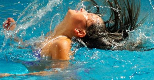 a woman laying in the water in a pool at La Cle des Champs in Provency