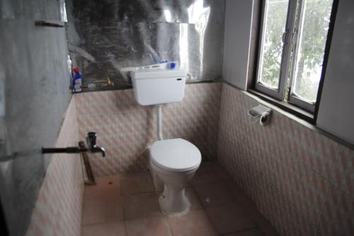 RavanglaにあるVamoose Borong Polok Village Homestayのトイレと窓のある小さなバスルーム